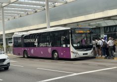 airport shuttle bus waiting outside a terminal