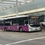 airport shuttle bus waiting outside a terminal