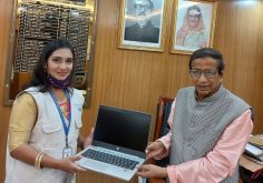 professionals working with AI tools on laptops in office