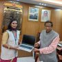 professionals working with AI tools on laptops in office