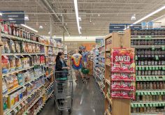 Shelves of packaged foods in a supermarket aisle.
