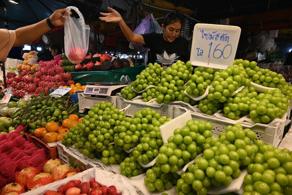 Shoppers browsing fresh vegetables at a farmers market stall