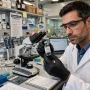 Researchers working on a personalised cancer vaccine in a laboratory
