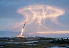 SpaceX rocket launch creating a glowing jellyfish cloud in the dawn sky over the US East Coast