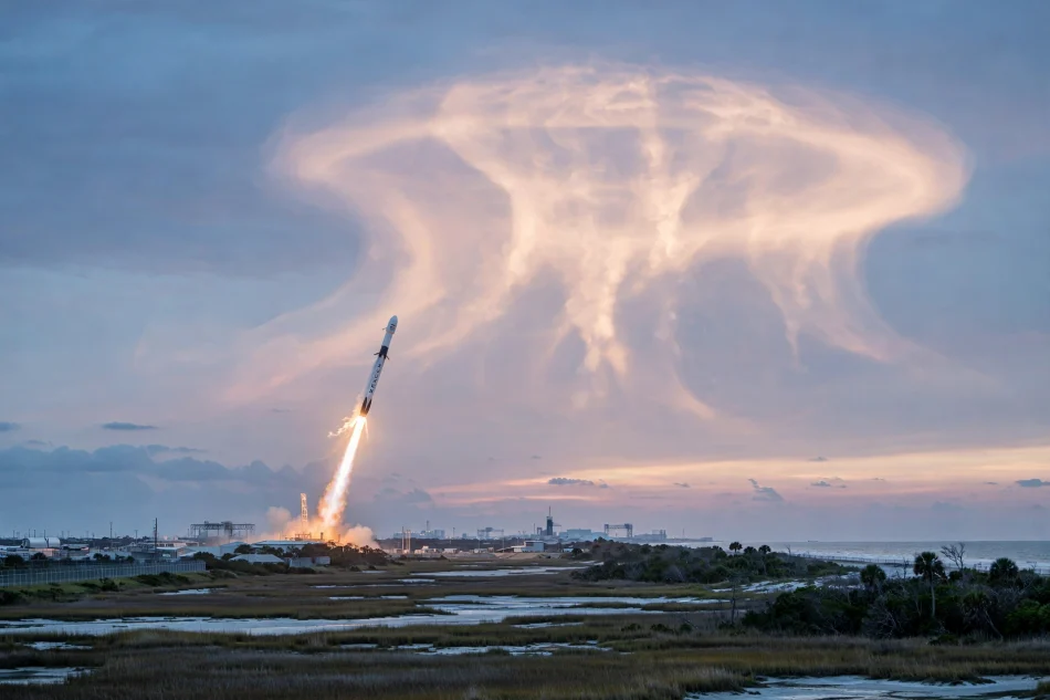 SpaceX rocket launch creating a glowing jellyfish cloud in the dawn sky over the US East Coast