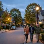 Friendly residential street at dusk with warm street lighting