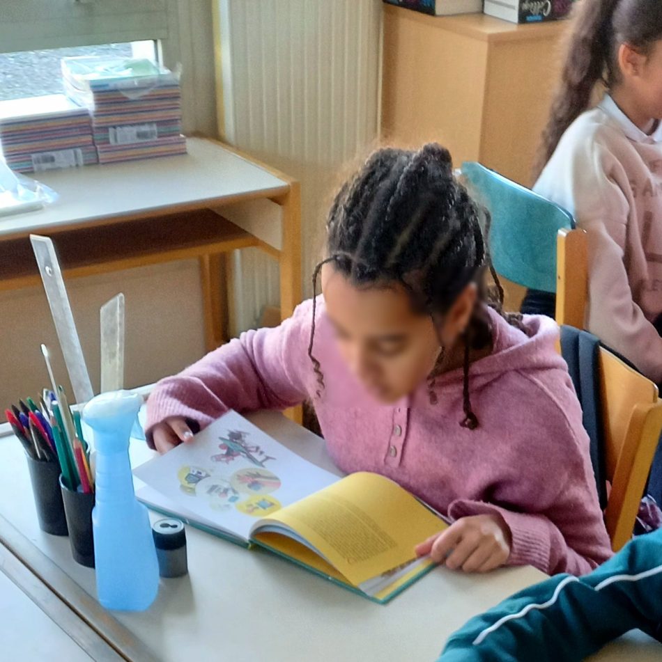 School students with phones stored away, focused on a lesson